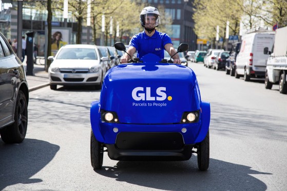 A deliveryman drives an e-scooter