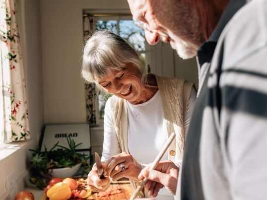 A senior couple is smiling