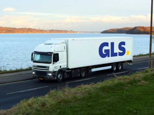 GLS truck drives by the water